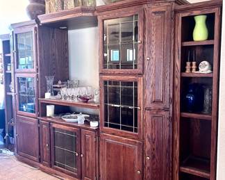 Wood TV entertainment center with glass display cabinets