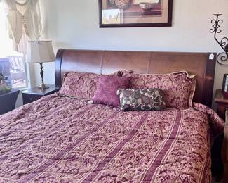 King sized bed, king sized sheets, comforter, mattress, and wood headboard
