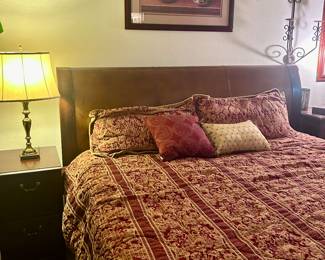 King sized bed, king sized sheets, comforter, mattress, and wood headboard