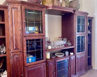 Wood TV entertainment center with glass display cabinets