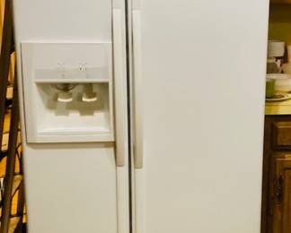 White Whirlpool Side by Side Refrigerator/Freezer.