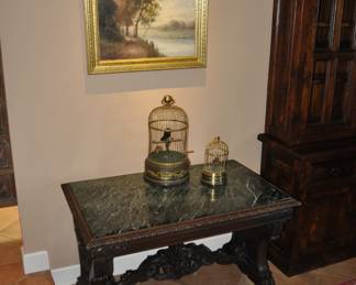 Antique marble top library table with antique music playing bird cages