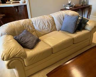 Benchmark off white leather couch and mid-century coffee talble, sofa table with smoke glass in the back ground
