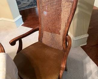 One of the 8 chairs for the dining table with cane back and soft gold bottoms