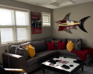 Two piece sectional sofa and cowhide ottoman