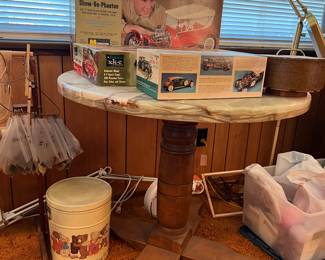 Mid century modern marble and wood table, vintage car models and toys