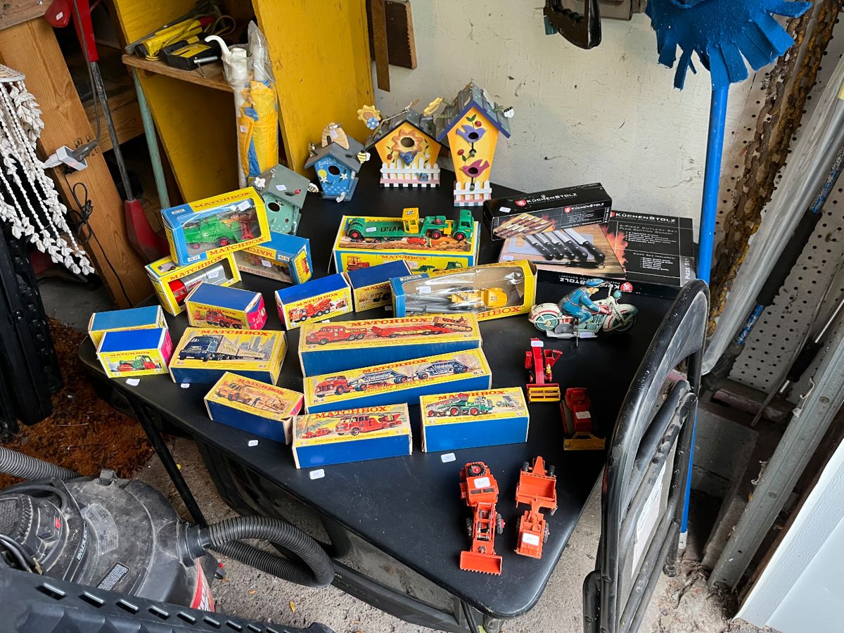 Vintage matchbox cars most still in original box, bird houses and sets of steak knives.