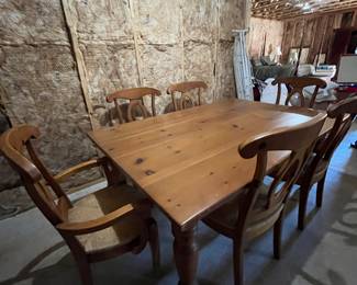 Pine dining table with six chairs (two are captain).   Spot on Tabletop needs some tlc.  