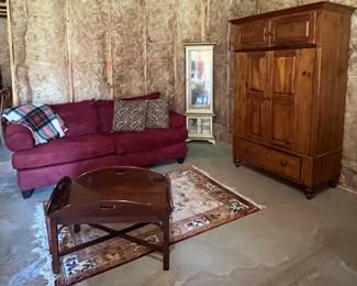 Curio, pine armoires red couch, rug and coffee table 
