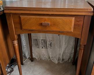 Vintage Singer sewing machine in cabinet