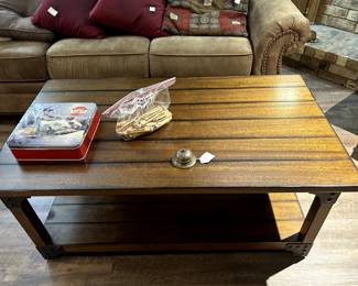 coffee table, vintage bell, vintage clothes pins, and Thomas Kinkade tin with lights and music