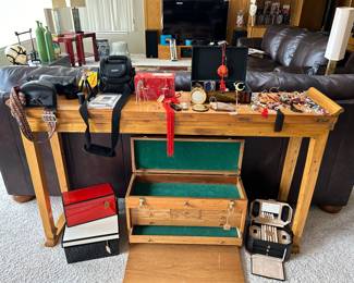 Lacquer boxes,  jewelry armoire, leather jewelry box, various jewelry pieces, vintage compact cases, cameras, cases, film. Large console table 5.5 x13” x34”, Samsung 65” flatscreen TV