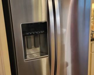 Whirlpool side by side stainless steel refrigerator/freezer