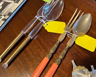 each one of these serving sets is very very pretty and very unusual. On the left is a lucite with 24 karat gold filled handle. On the right is a set made in France With a very pretty neck, coral colored handles, and horn ends