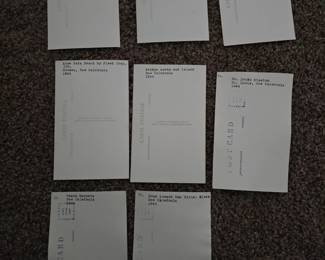 The back of post cards each have a typed description