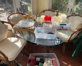 Glass top table with 4 chairs on casters. 