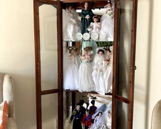 glass display case collection of dolls vases
