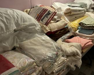 Lots of linens, souvenir table cloths scarves and pillow covers