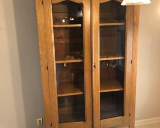Great grandmothers' oak wardrobe. Has been refinished with glass panels, and shelves made. Carved top not pictured. Good condition.