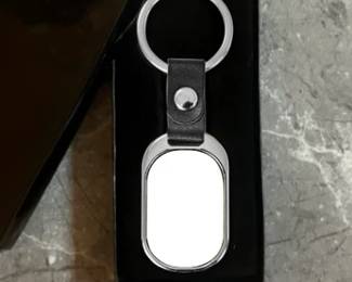 Oval Sublimatable Keychain with White Insert - 3-5/8" x 1-3/8".  Made with high-quality stainless steel, aluminum, and leather. Comes in a gift box.

