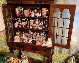 China cabinet; collection of Toby mugs; David Winter cottages.