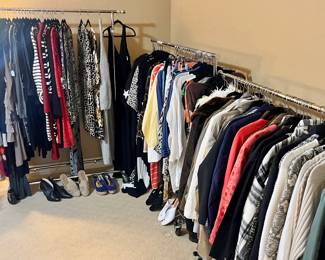 CLOTHING ALL AROUND THE ROOM. SIZES MEDIUM, LARGE, AND XL.