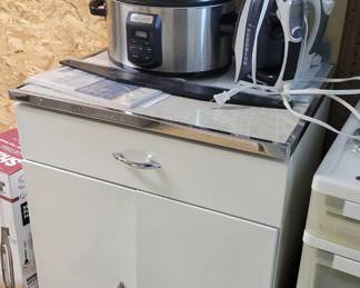 Crock pot.  Storage cabinet 