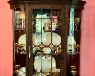 Wonderful curved front curio cabinet - filled with Lenox china and gold rimmed crystal stems!