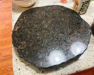 This is a heavy stone top lazy Susan 
