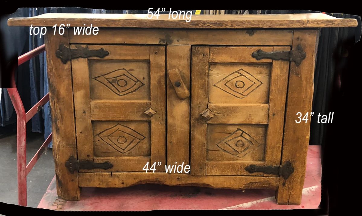 a spanish colonial style narrow cabinet 300.00