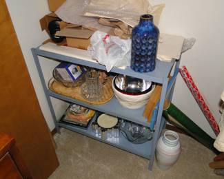 Metal shelf with stuff in closet