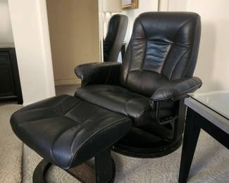 Leather swivel chair with foot stool. 