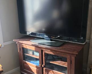 Large TV with cabinet stand