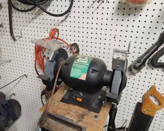 Grinder and wall full of tools