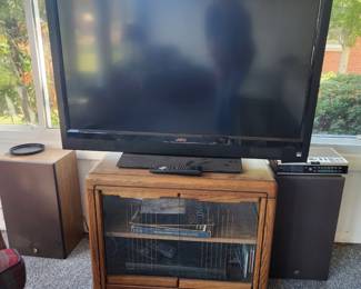 Several TVs and TV stands, 2 sets of speakers