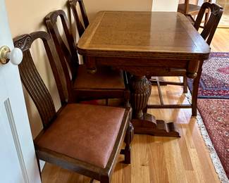 OAK TRESTLE TABLE WITH PULL OUT LEAVES AND FOUR LEATHER SEAT CHAIRS
