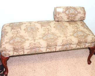 Upholstered bench with pillow.