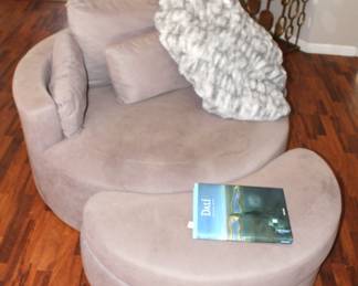 Upholstered chair with storage ottoman.