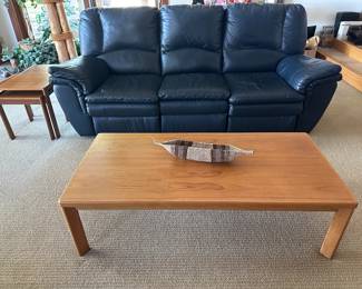 Teak coffee table; navy blue leather sofa with reclining ends