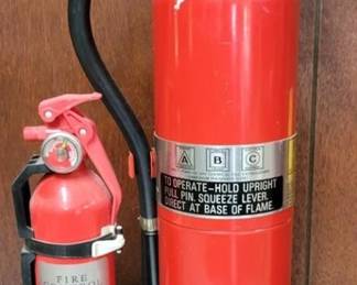 810 - 2 Fire Extinguishers Large Extinguisher is empty, smaller one indicates full
