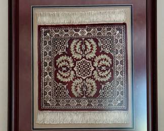 Small silk rug framed as a wall hanging