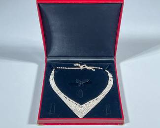 DIAMOND SIMULANT NECKLACE | Designed as a curved v-shape diamond simulant necklace, in a red alligatored presentation box. - w. 7 x l. 11.5 in
