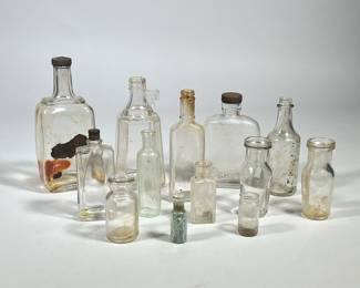 (13pc) MIXED ANTIQUE & OTHER CLEAR GLASS BOTTLES | Mixed lot of antique and other clear glass bottles, including apothecary jars/bottles, etc. - h. 8 x w. 2.5 x l. 3.5 in (largest)