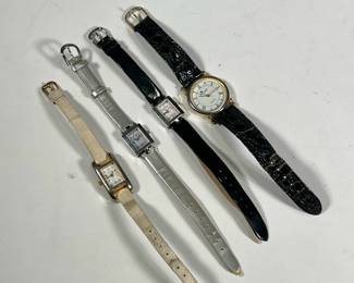(4pc) LADY'S FASHION WATCHES | Including two Nine West watches, one on a clack band the other on silver, a Louis Santini quartz watch on a black band, and an unmarked quartz watch on a beige leather band.