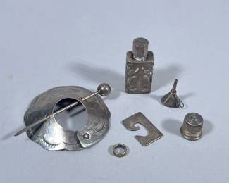 MIXED STERLING SILVER | Including: Sterling silver penannular brooch (20.2g), Sterling silver thimble marked “Sterling” (3g), miniature sterling funnel marked “925” (1.3g), Sterling silver bottle opener marked “Sterling / Leonore Doskow Inc.” (6.9g), sterling band marked “925” (1.2g), and miniature perfume bottle with sterling silver case marked “925” (21.4g with glass), Total weighable silver: 32.7g