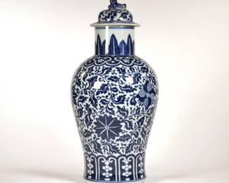 CHINESE BLUE & WHITE LIDDED JAR | Chinese porcelain jar decorated with scrolls and leaves, the lid with a foo dog finial. - h. 18.5 x dia. 9 in