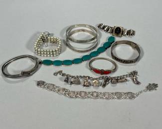 (10pc) SILVER Bracelet Lot | Sterling silver and silver-toned bracelets, including four sterling silver bracelets with fineness marks, one stamped "MEXICO" (all together 2.35 ozt); and other costume bracelets including a silver-toned child's bracelet with red enamel, a book-form locket bracelet, a faux pearl bracelet, a charm bracelet, and others. -  l. 7 in (Longest)
