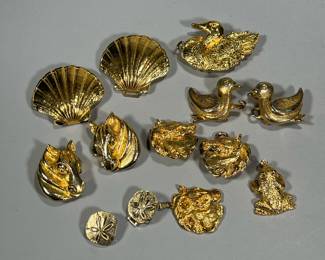 MIMI Di N GOLD TONE BELT BUCKLES & PENDANTS | Including a pair of ducks belt buckle, a pair of seashells belt buckle (h. 3 in), a pair of horses belt buckles; a frog pendant; a horse-head group - pair horses belt buckle and matching pendant; plus a single swan buckle and unmarked sand-dollar buckles.