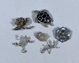 (6pc) STERLING & OTHER BROOCHES/PINS | Including: Sterling silver rose-form brooch marked “STERLING / MEXICO” (10g), frog form brooch with mounted stones marked “925” (5g), salamander/form brooch marked “925” (2.6g), beetle-form brooch with mounted stones marked “925” (6.8g), turtle brooch/pendant with mounted stones marked “SILVER / 925” (14.7g), and flower form brooch with inlay shell (6.9g); Total weight: 45.9g.
