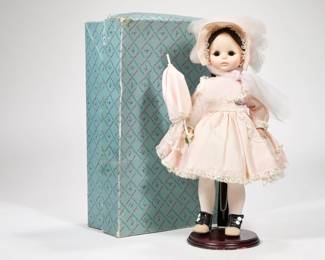 MADAME ALEXANDER "REBECCA" DOLL | "Rebecca" doll by Madame Alexander with brown eyes and brunette hair in pink dress in original box. Doll height: 13in - h. 4.5 x w. 9 x l. 14 in (box)
